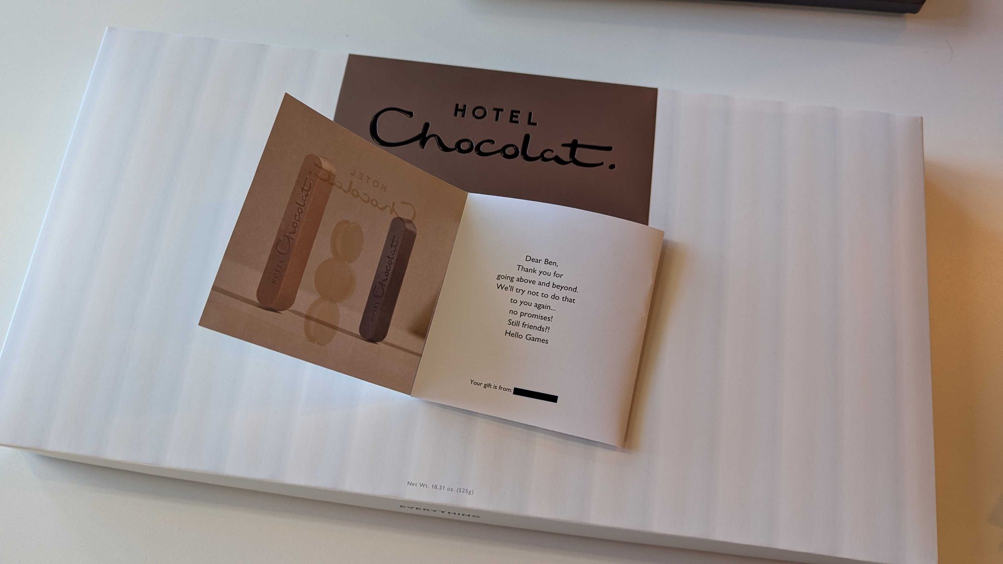 A large white box of Hotel Chocolat chocolates. A thank you note sits on top of the box